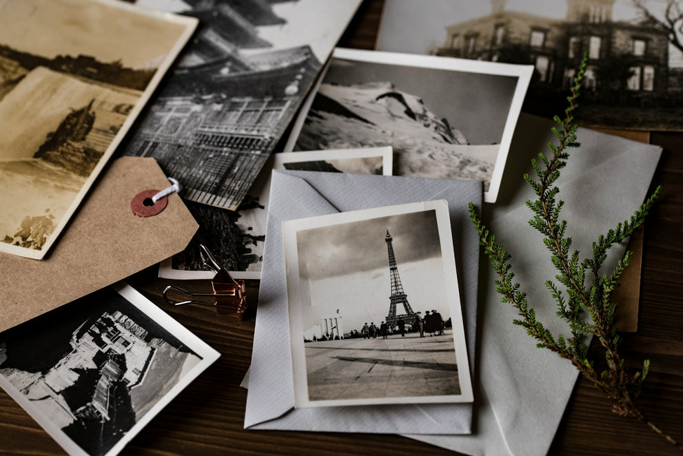 Grayscale photo of eiffel tower on top of white envelopes