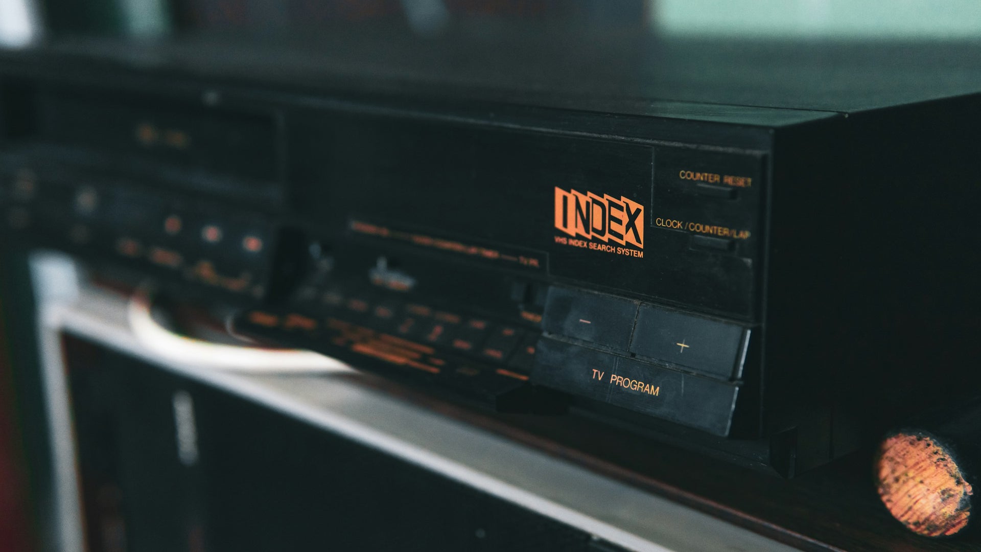 VHS player sitting on a shelf. 