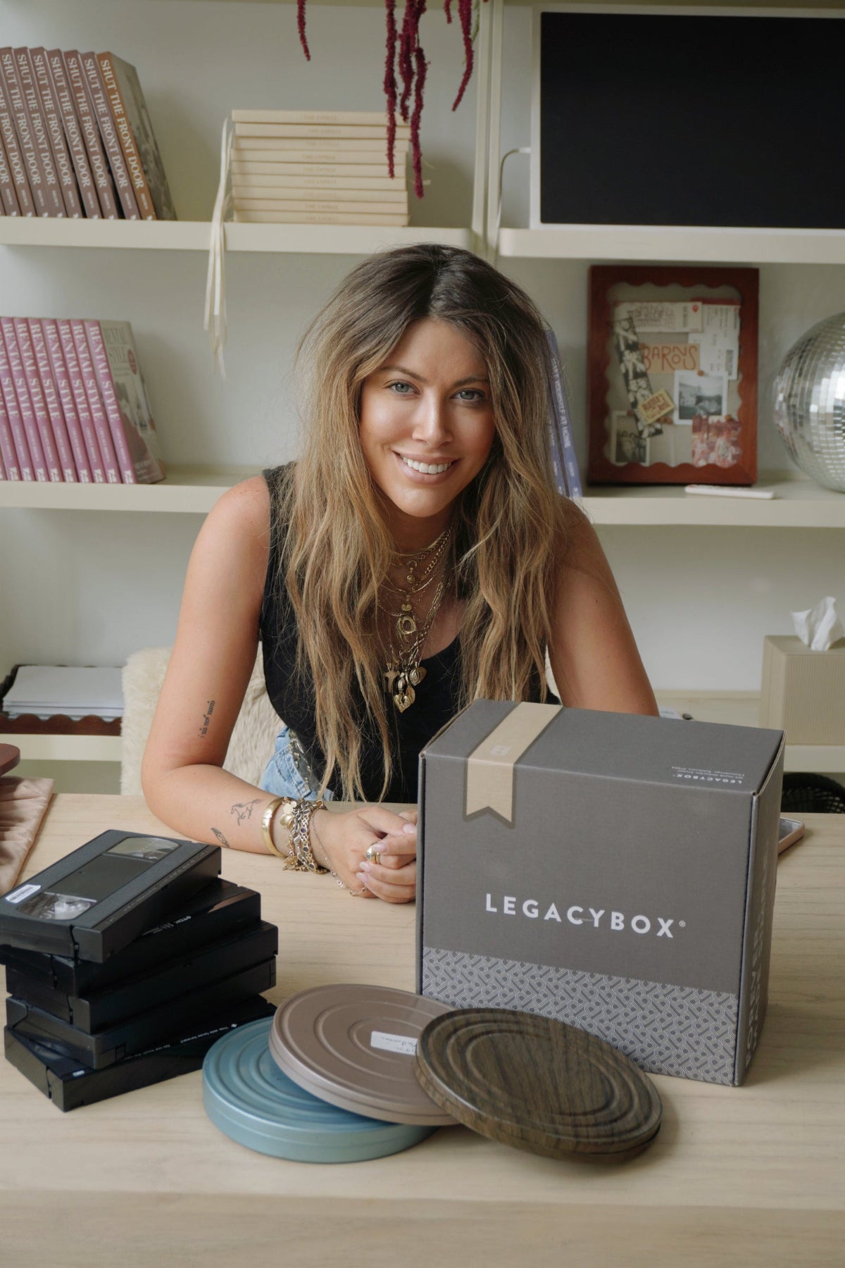 Chelsey Brown smiling with a Legacybox kit and preserved memories