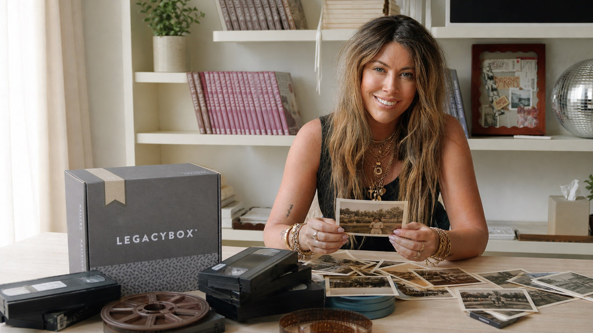 Chelsey Brown holding a family photo beside a Legacybox kit